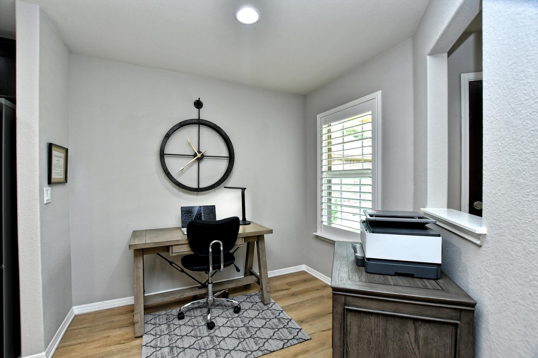 231 Hobby Street Georgetown, TX 78633 - Photo 14 of 29 An inviting home office with wood-look flooring and a naturally illuminated window.
