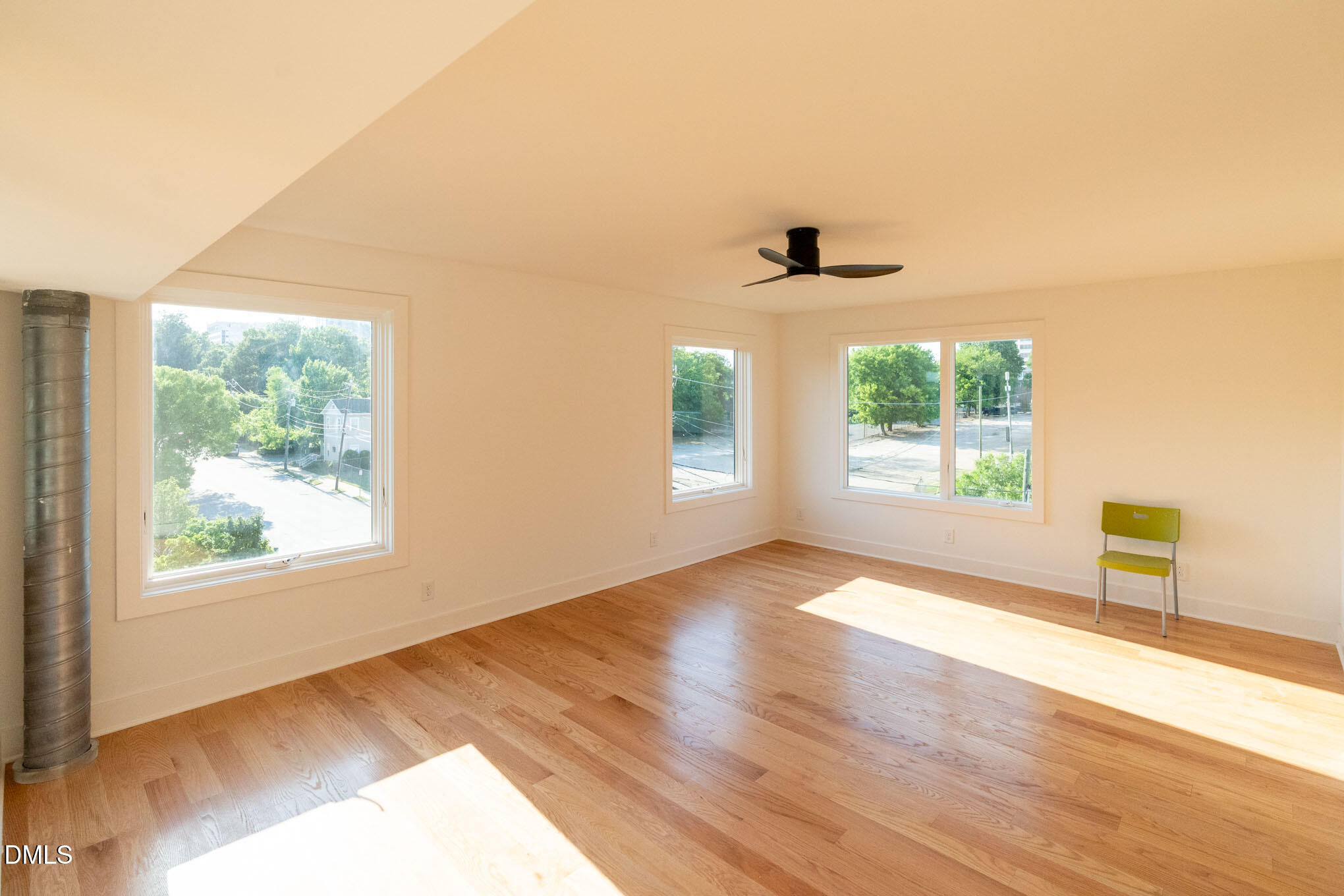 400 East Martin Street, Unit A Raleigh, NC 27601 - Photo 15 of 29 an empty room with wooden floor and windows