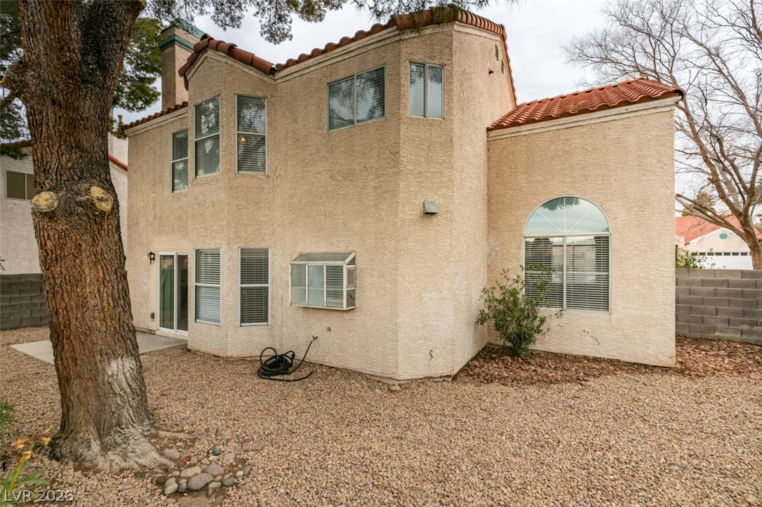 1738 Toltec Circle Henderson, NV 89014 - Photo 43 of 46 Mediterranean-inspired architecture with stucco siding and red tile roof offers a private outdoor area.
