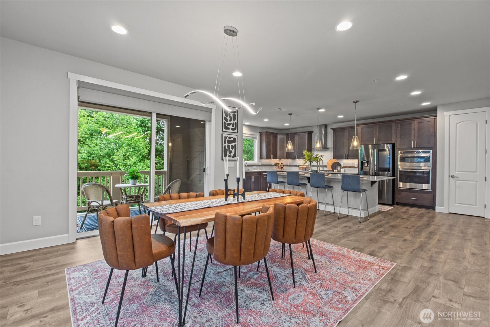 18231 3rd Drive Southeast Bothell, WA 98012 - Photo 6 of 40 a dining room with stainless steel appliances granite countertop a stove a refrigerator a oven with a dining table and chairs