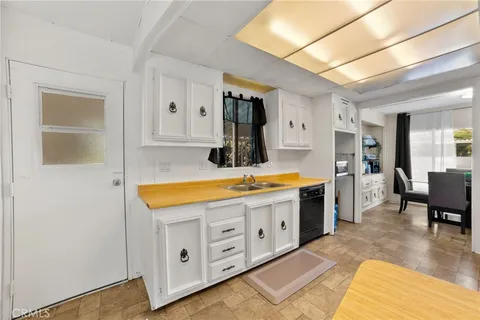 a spacious bathroom with a granite countertop sink and a mirror