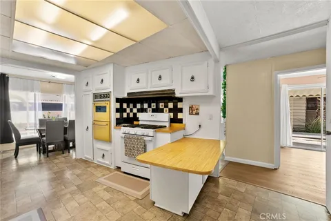a kitchen with stainless steel appliances granite countertop a sink a stove and a refrigerator