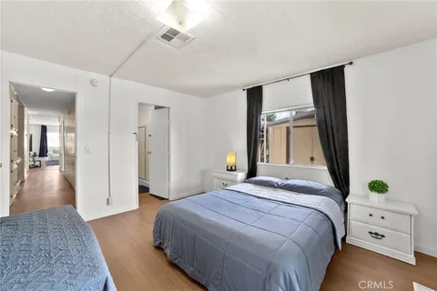 a bedroom with two beds and a chandelier