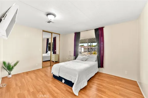 a bedroom with a bed and a potted plant