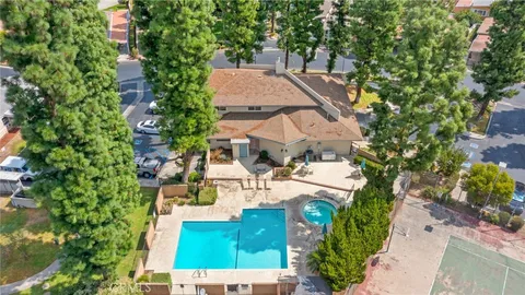 an aerial view of a house with a garden and trees