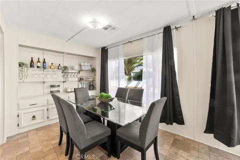 a dining room with furniture and window