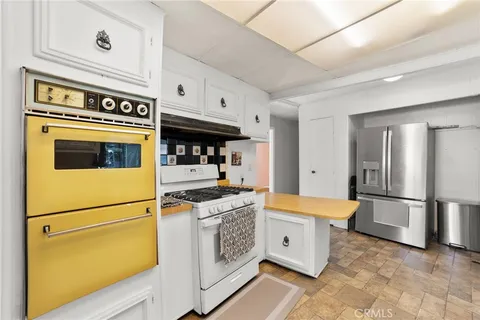 a kitchen with stainless steel appliances granite countertop a stove a refrigerator and a refrigerator