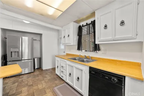 a spacious bathroom with a granite countertop sink and a mirror