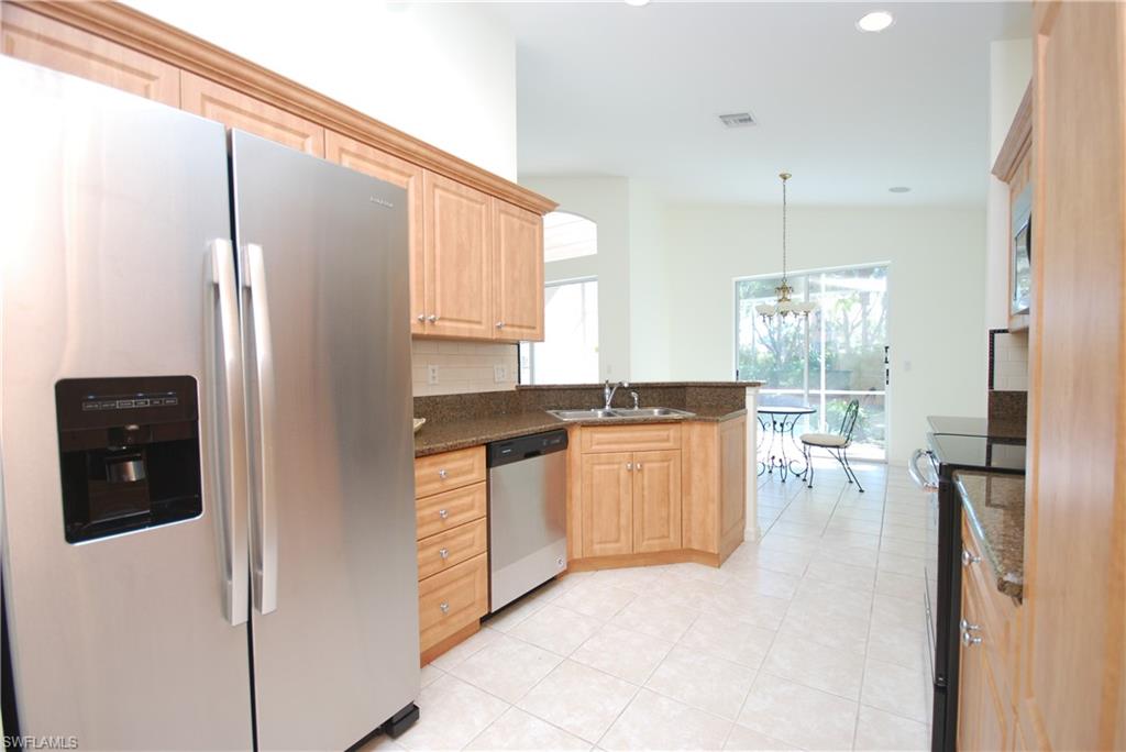 9200 Springview Loop Estero, FL 33928 - Photo 1 of 25 a kitchen with stainless steel appliances granite countertop a refrigerator and a sink