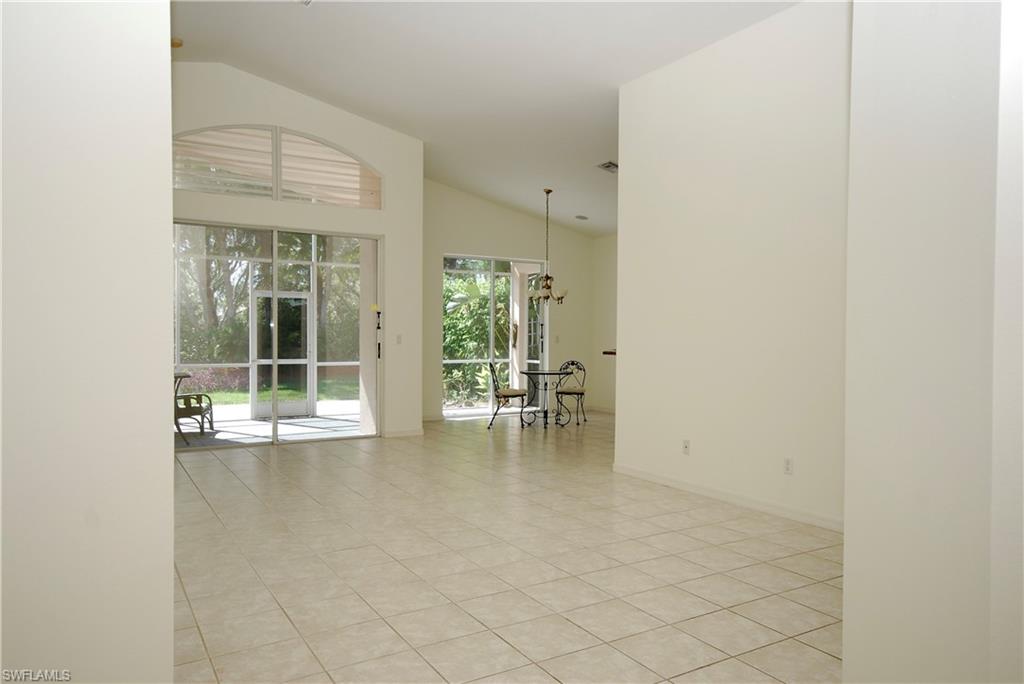 9200 Springview Loop Estero, FL 33928 - Photo 2 of 25 an empty room with sliding door and wooden floor