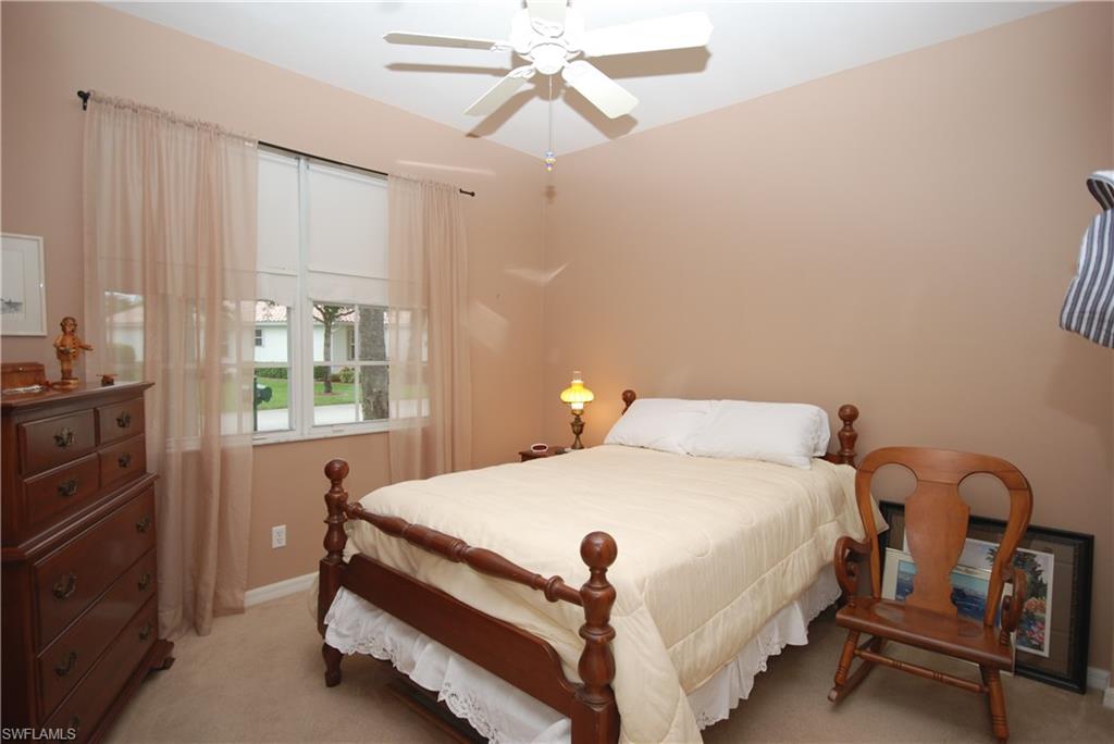 9200 Springview Loop Estero, FL 33928 - Photo 8 of 25 a bedroom with a bed and a chandelier fan