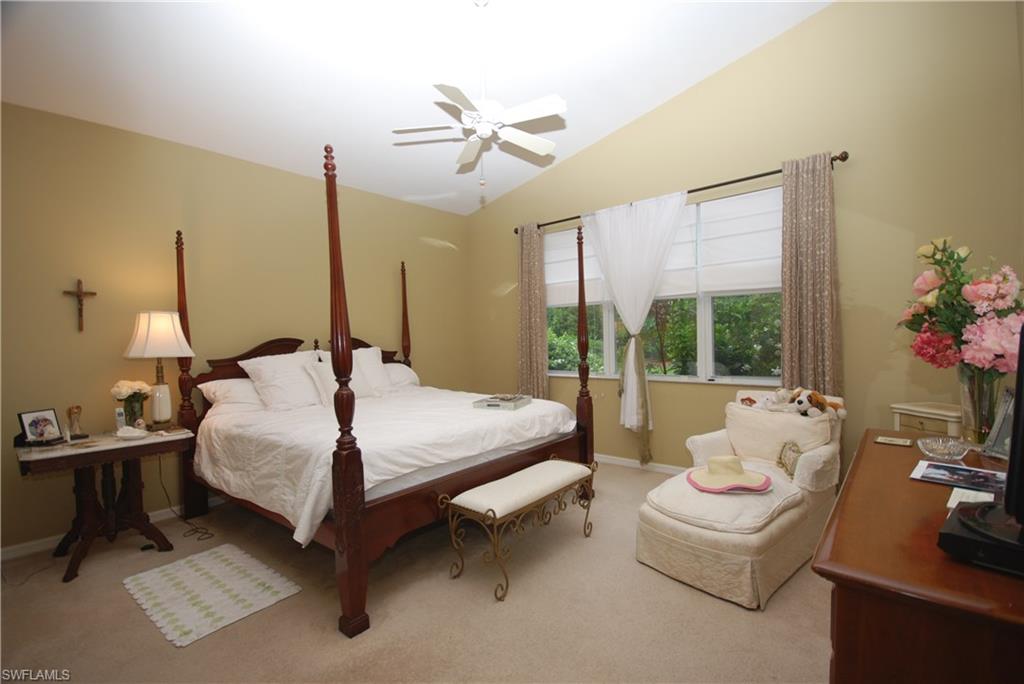 9200 Springview Loop Estero, FL 33928 - Photo 10 of 25 a bedroom with a bed and large windows