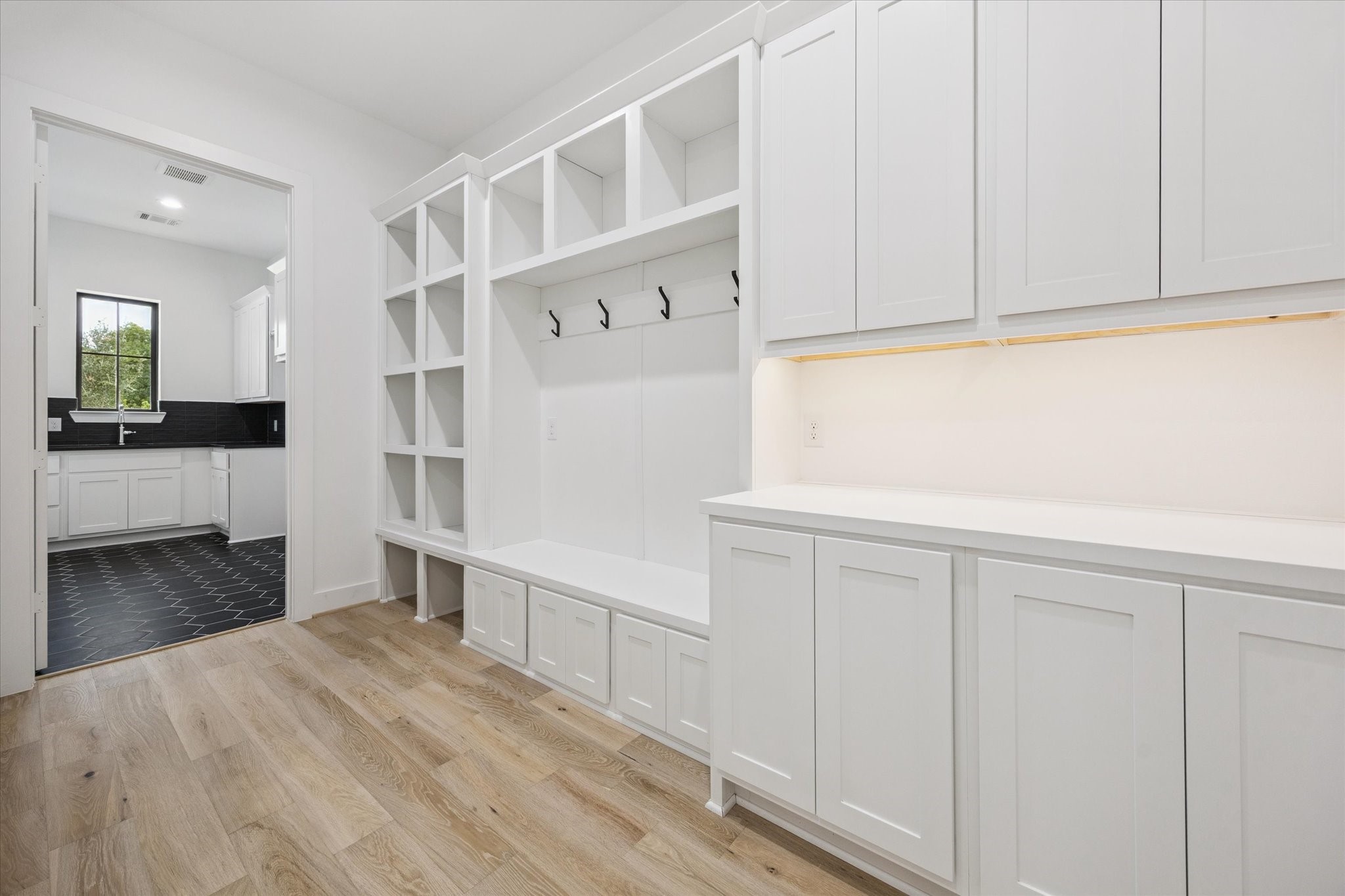1201 Confederate Road Houston, TX 77055 - Photo 23 of 33 A well-appointed mudroom offers built-in cubbies, coat hooks, and abundant cabinetry to keep daily essentials organized and out of sight.