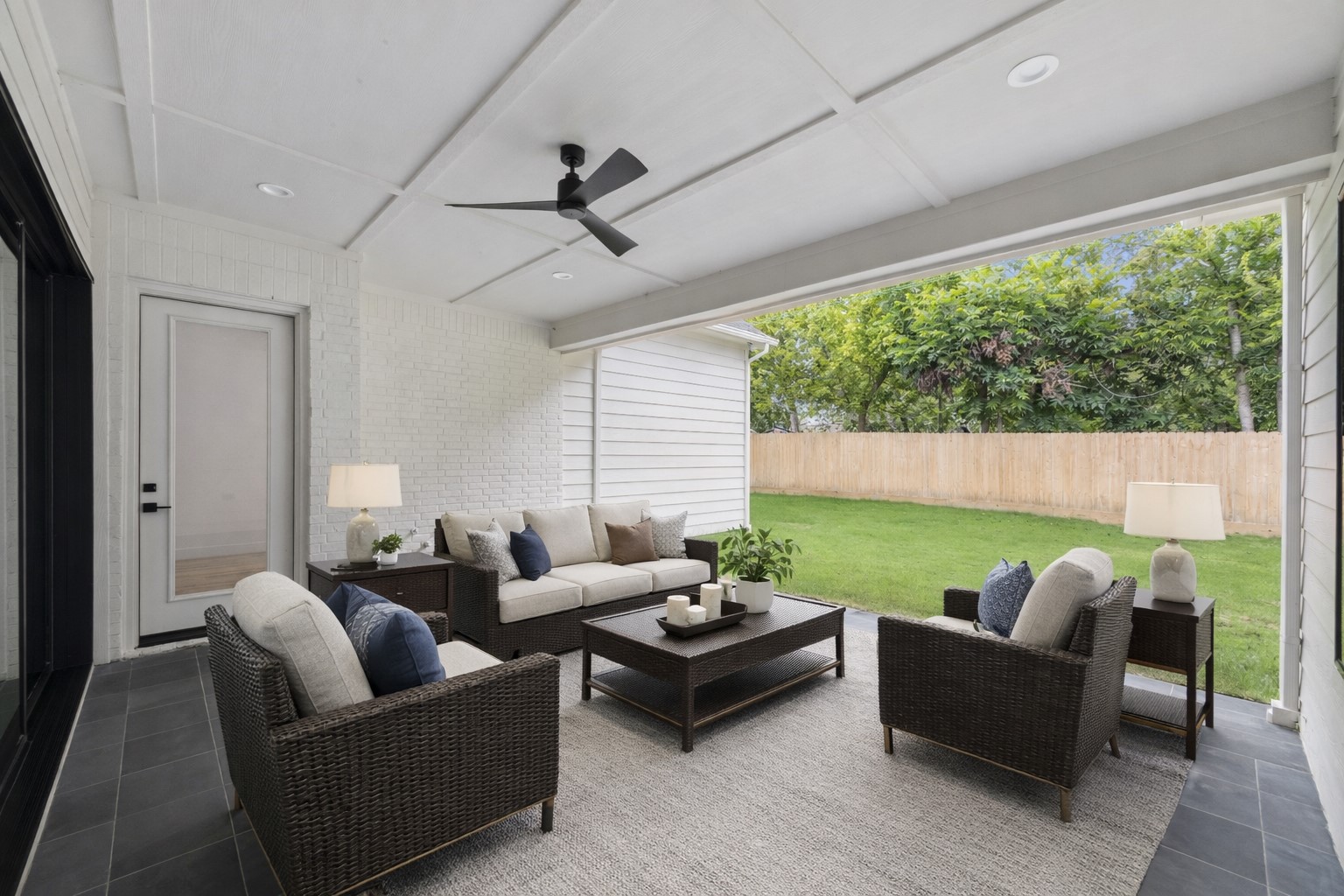 1201 Confederate Road Houston, TX 77055 - Photo 25 of 33 Spacious covered patio with ceiling fan and outdoor hookups—ready for future kitchen build-out or weekend hangouts overlooking the backyard. *Virtually Staged*