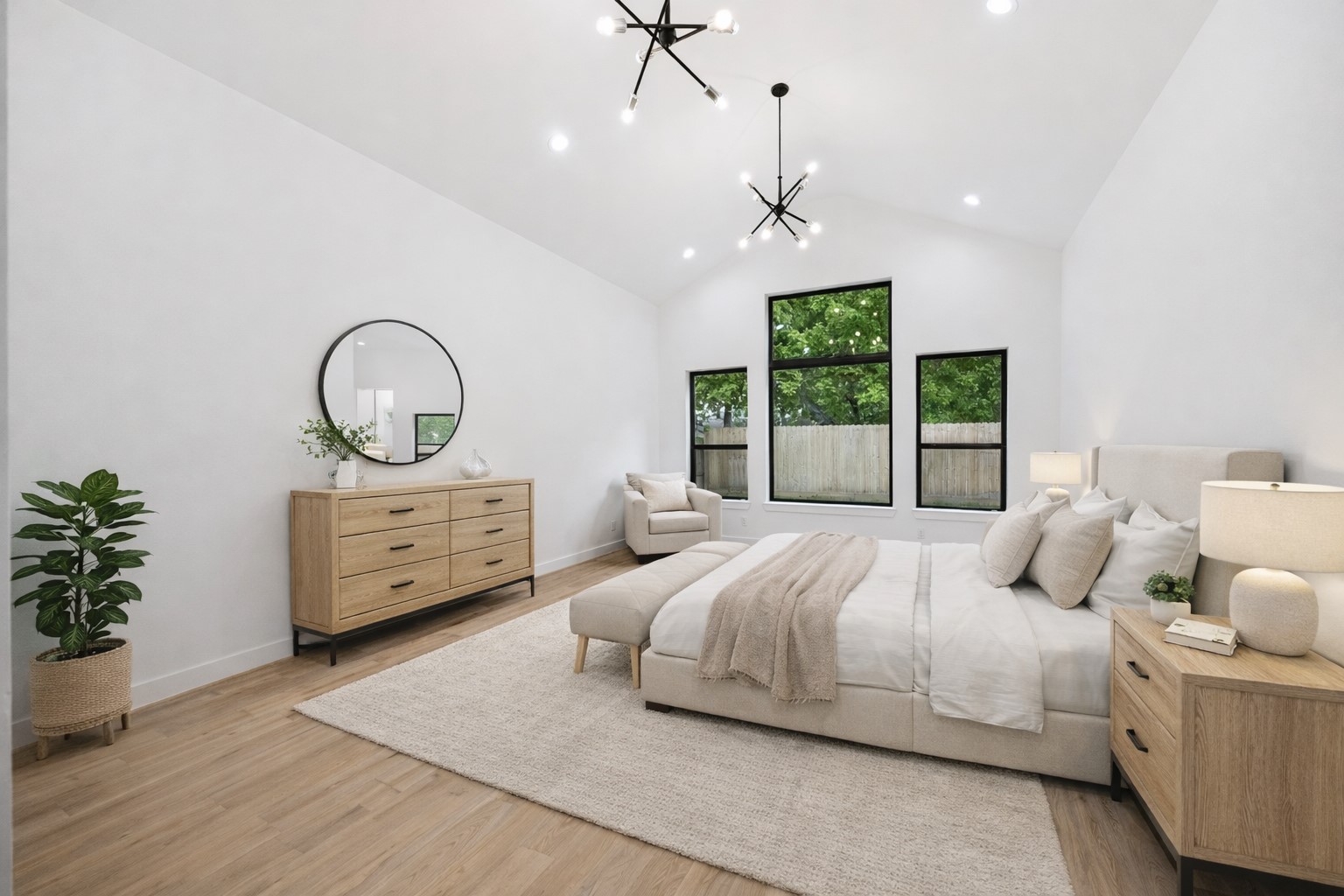 1201 Confederate Road Houston, TX 77055 - Photo 10 of 33 Vaulted ceilings, oversized windows, and modern chandeliers elevate the spacious primary suite, filling it with natural light and architectural interest. A serene retreat that blends bold design with everyday comfort. *Virtually Staged*