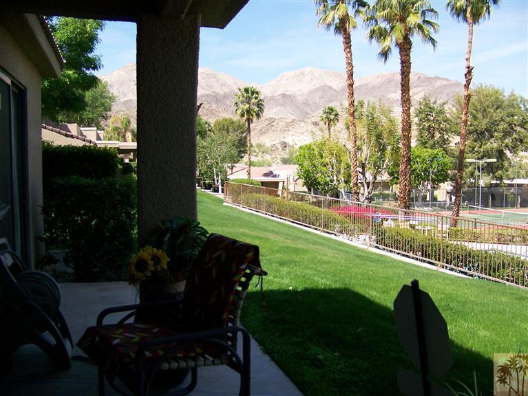 72400 Ridgecrest Lane Palm Desert, CA 92260 - Photo 24 of 25 a view of a swimming pool and lounge chairs in patio with a lake view