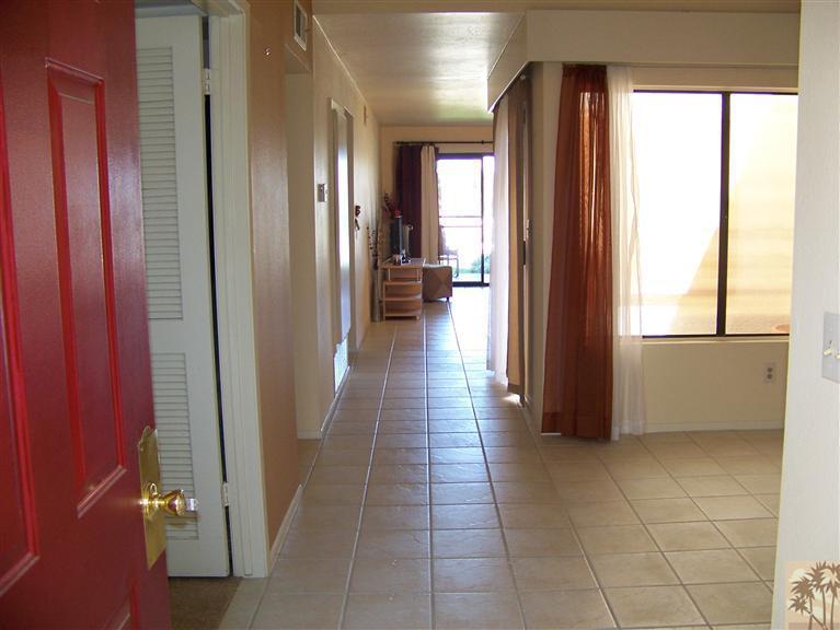 72400 Ridgecrest Lane Palm Desert, CA 92260 - Photo 4 of 25 a view of a hallway with wooden floor and windows