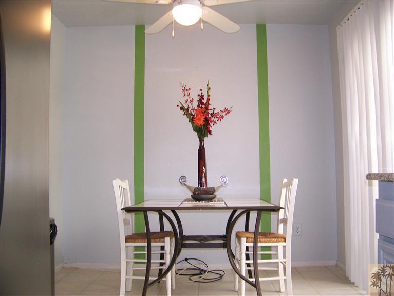 72400 Ridgecrest Lane Palm Desert, CA 92260 - Photo 8 of 25 a view of a dining room with furniture and a chandelier