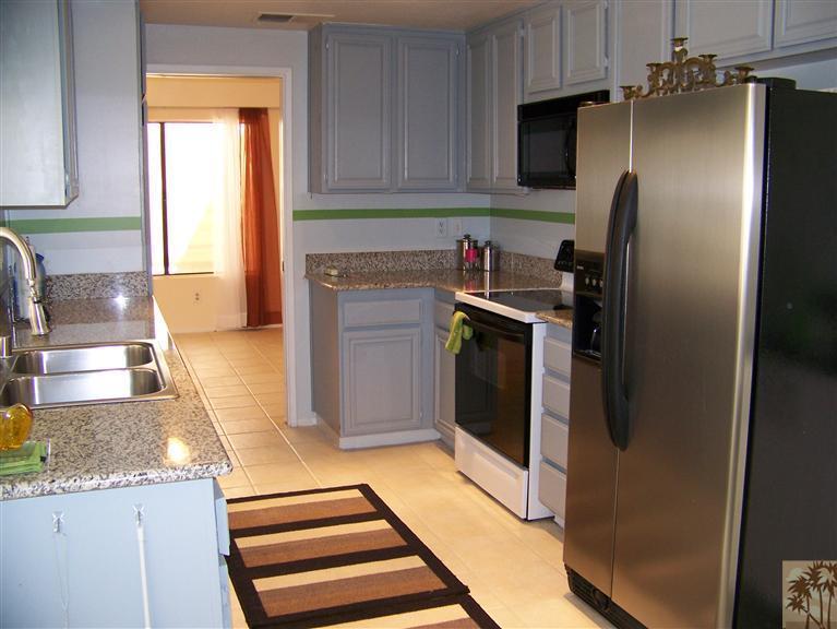 72400 Ridgecrest Lane Palm Desert, CA 92260 - Photo 10 of 25 a kitchen with stainless steel appliances granite countertop a refrigerator and a sink