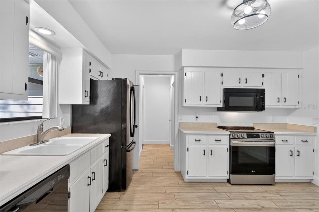 171 William Street Edgewater, FL 32141 - Photo 11 of 40 a kitchen with a sink stainless steel appliances and cabinets