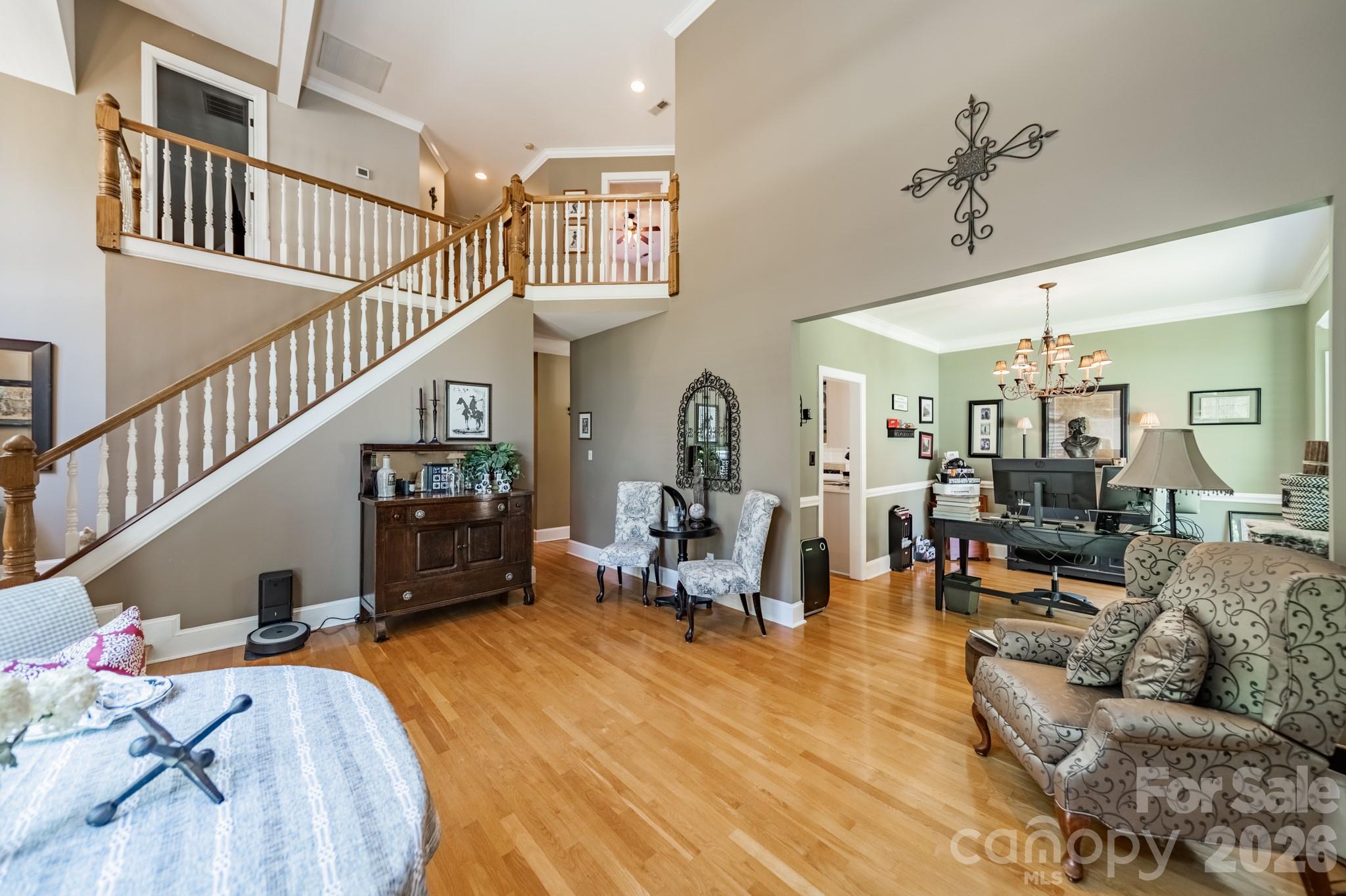 11043 Seven Coves Drive Tega Cay, SC 29708 - Photo 17 of 45 a living room with furniture or wooden floor and a chandelier