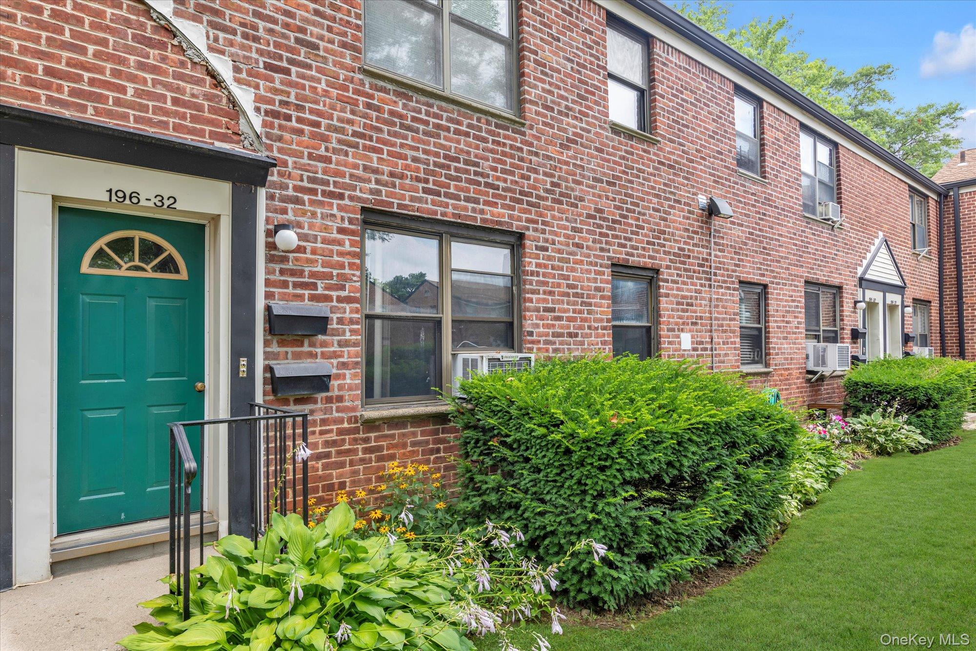 196-32 69th Avenue, Unit 1 Queens, NY 11365 - Photo 11 of 21 View of exterior entry with brick siding and cooling unit