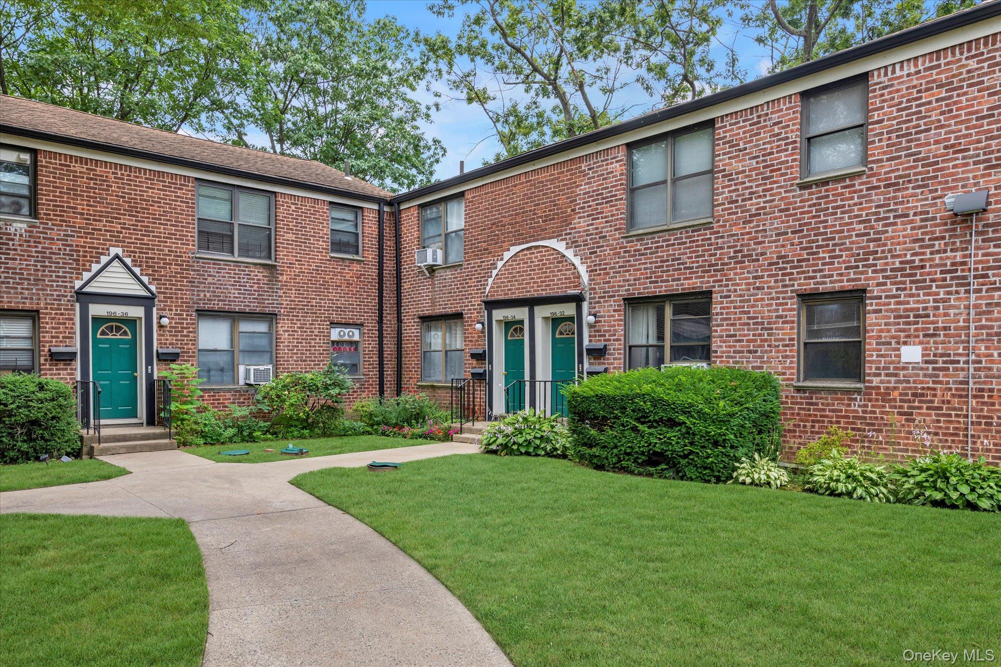 196-32 69th Avenue, Unit 1 Queens, NY 11365 - Photo 12 of 21 View of front of home featuring brick siding and a front lawn