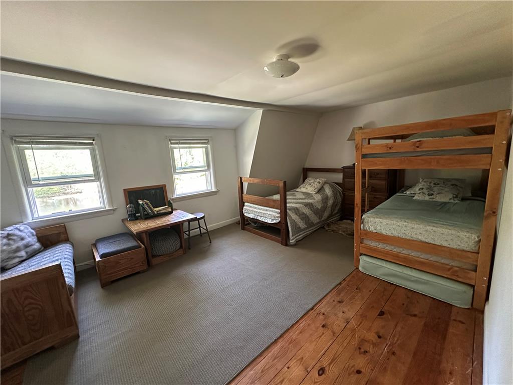 10 Kizer Pond Road Lake Ariel, PA 18436 - Photo 31 of 48 Two windows naturally illuminate this spacious bedroom, featuring both hardwood and carpeted flooring.