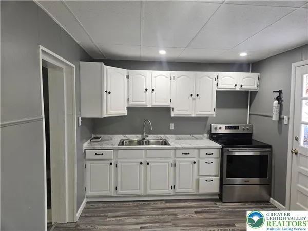 a kitchen with stainless steel appliances a stove sink and refrigerator