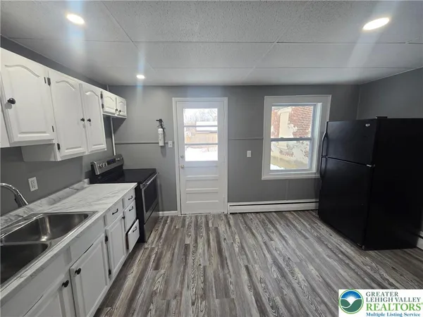 a kitchen with a refrigerator stove and sink