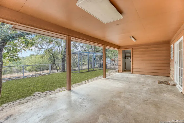 a view of an empty room with a large window and yard