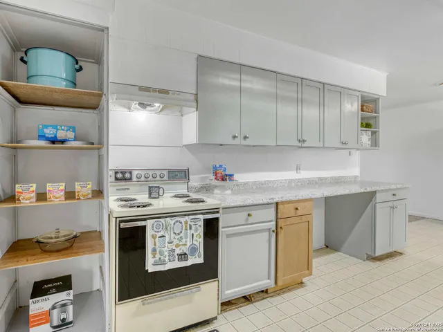 a kitchen with stainless steel appliances granite countertop a stove and a sink