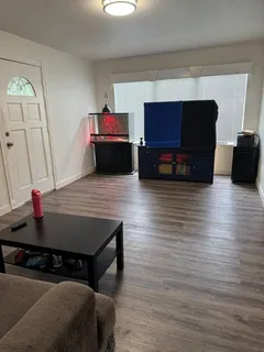 a living room with furniture and a flat screen tv