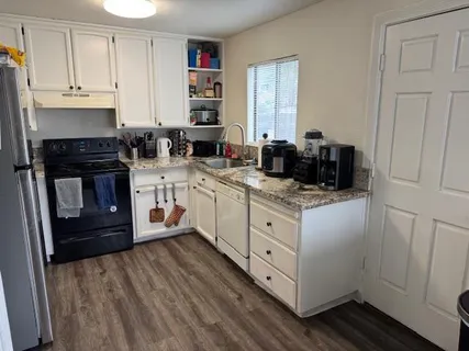 a kitchen with stainless steel appliances granite countertop a stove a sink and a refrigerator