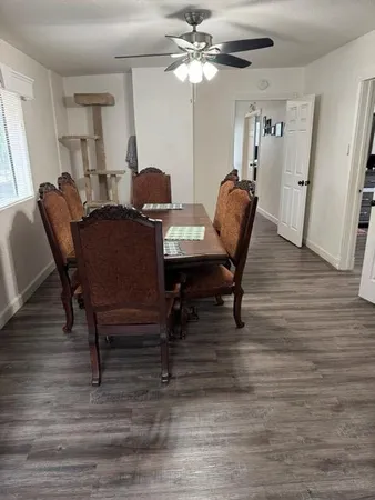 a view of a dining room with furniture and wooden floor