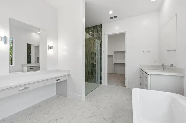 a bathroom with a double vanity sink toilet and shower