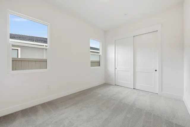 a view of an empty room with a closet