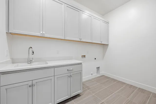a kitchen with white cabinets and a sink