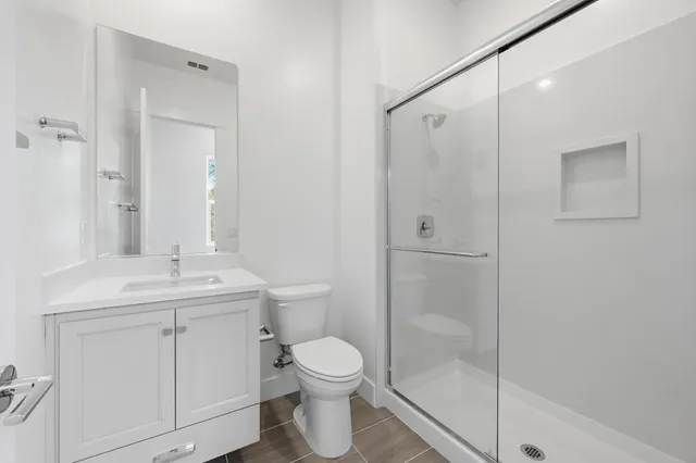 a bathroom with a toilet a sink and shower