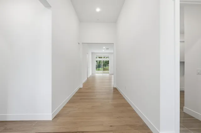 a view of a hallway with wooden floor
