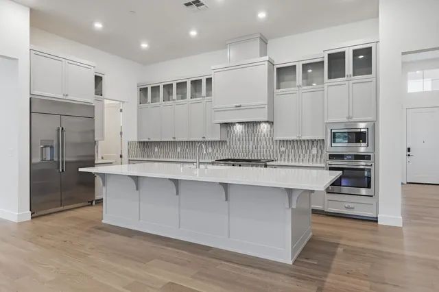 a kitchen with stainless steel appliances granite countertop a stove and a sink