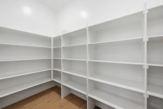 a view of walk in closet with empty racks