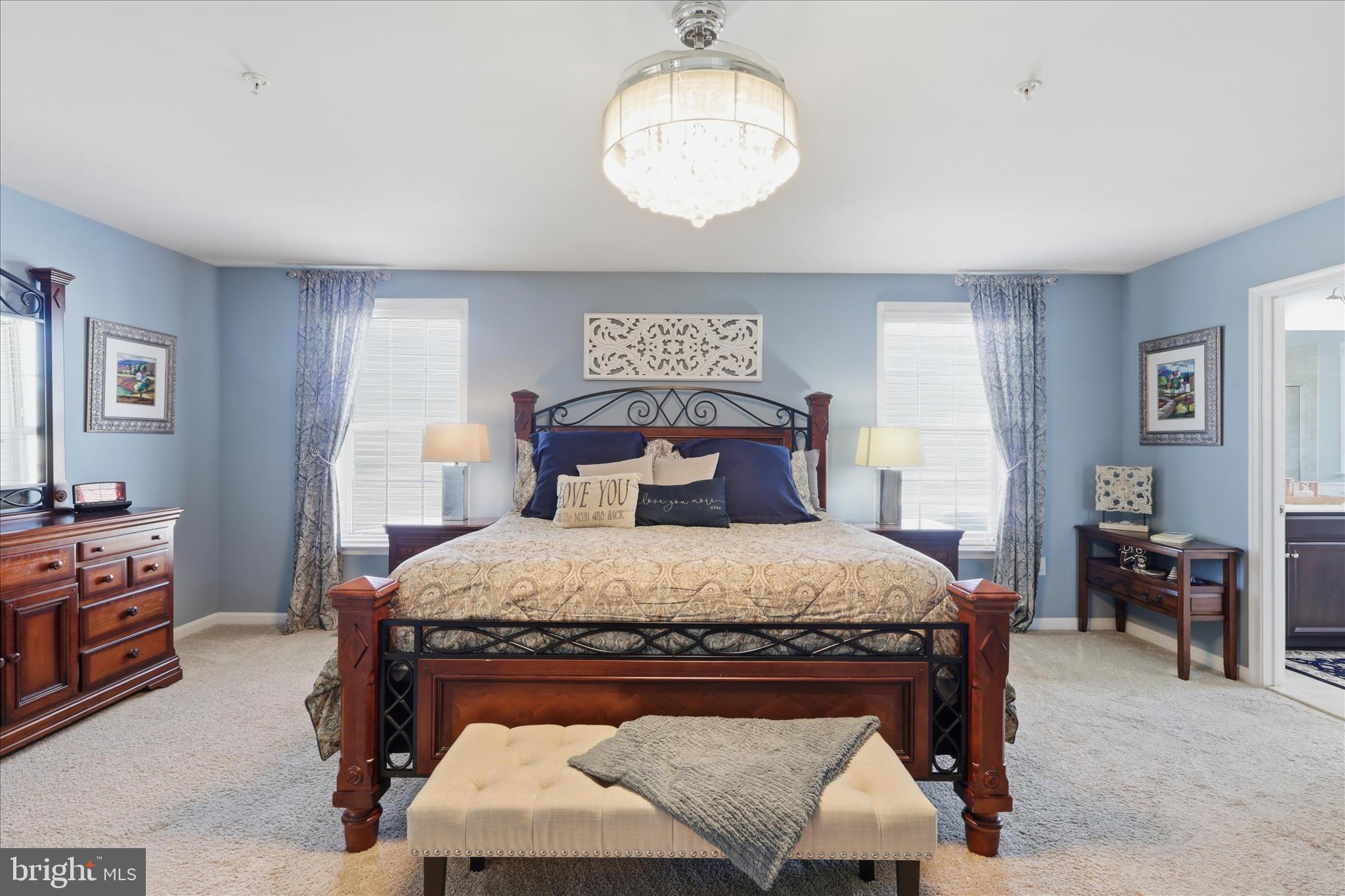 6606 Corbel Way Frederick, MD 21703 - Photo 25 of 60 a bed sitting in a bedroom next to a window with a table and chair