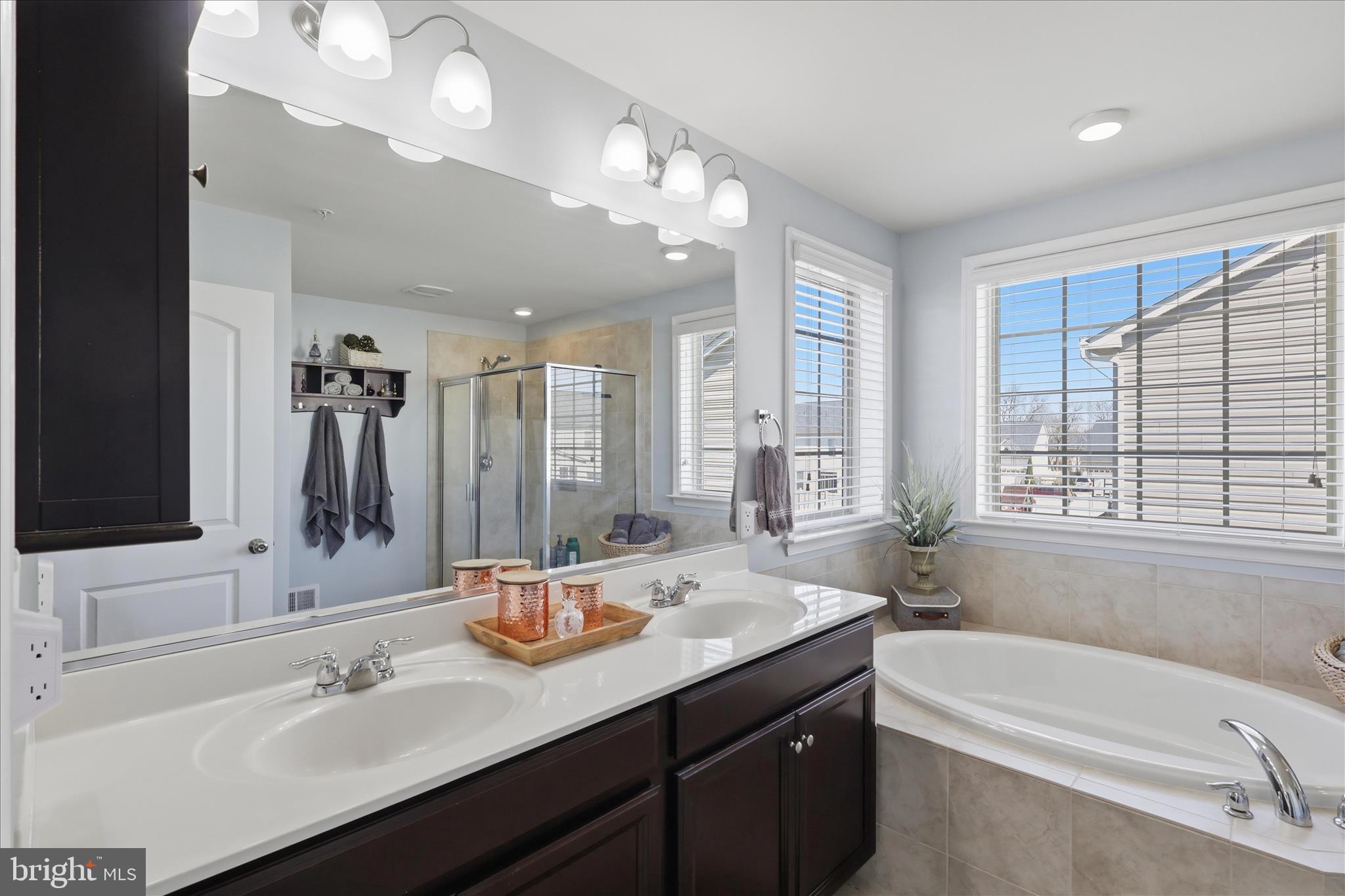 6606 Corbel Way Frederick, MD 21703 - Photo 28 of 60 a bathroom with a tub sink and mirror