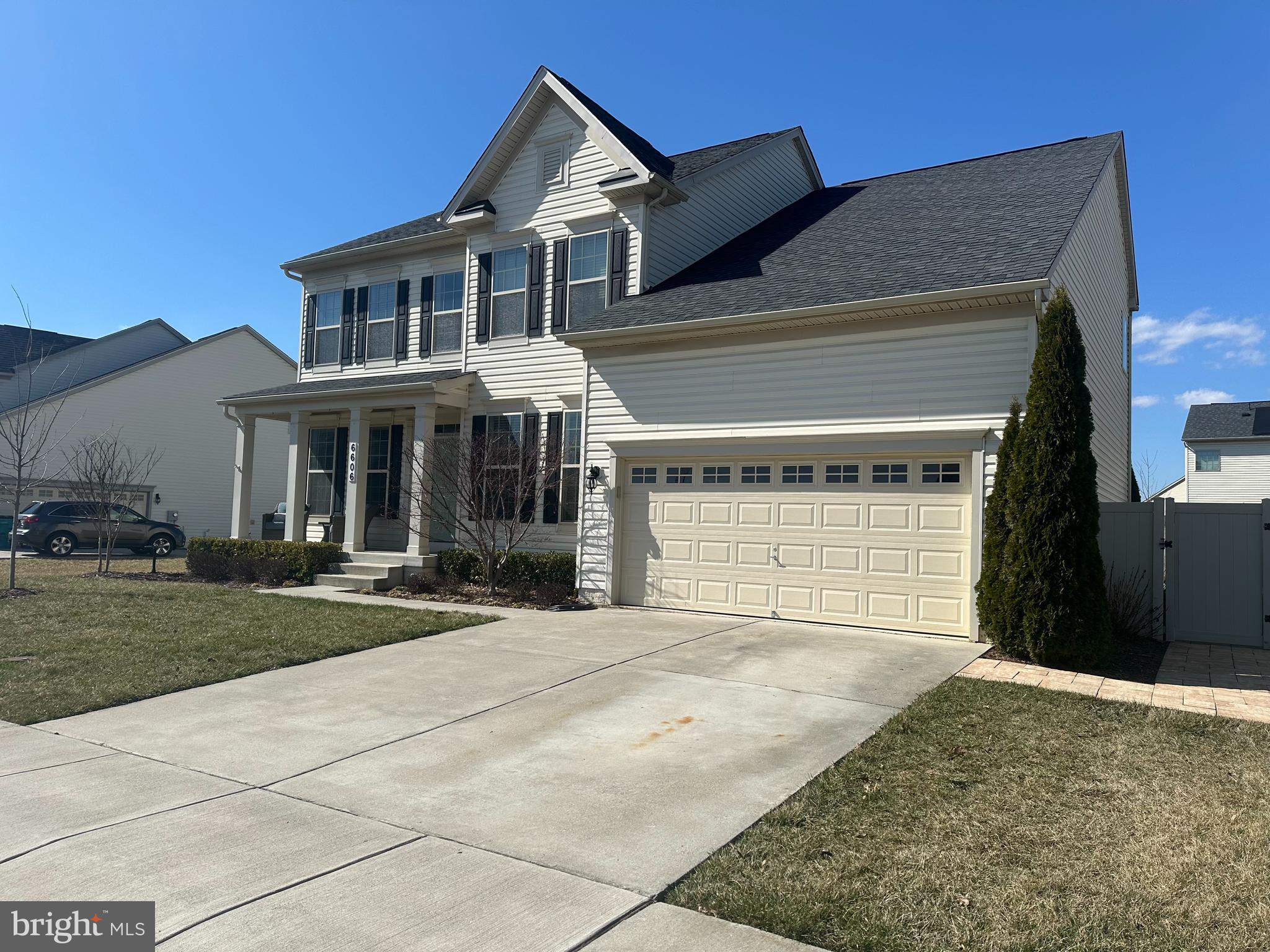 6606 Corbel Way Frederick, MD 21703 - Photo 3 of 5 a front view of a house with a yard and garage