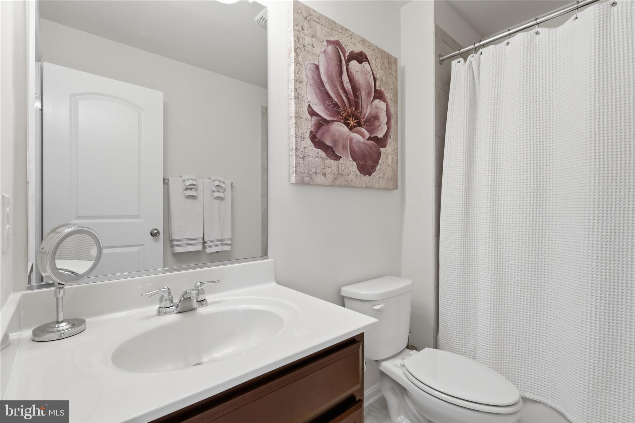 6606 Corbel Way Frederick, MD 21703 - Photo 35 of 60 a bathroom with a toilet sink vanity tub and mirror