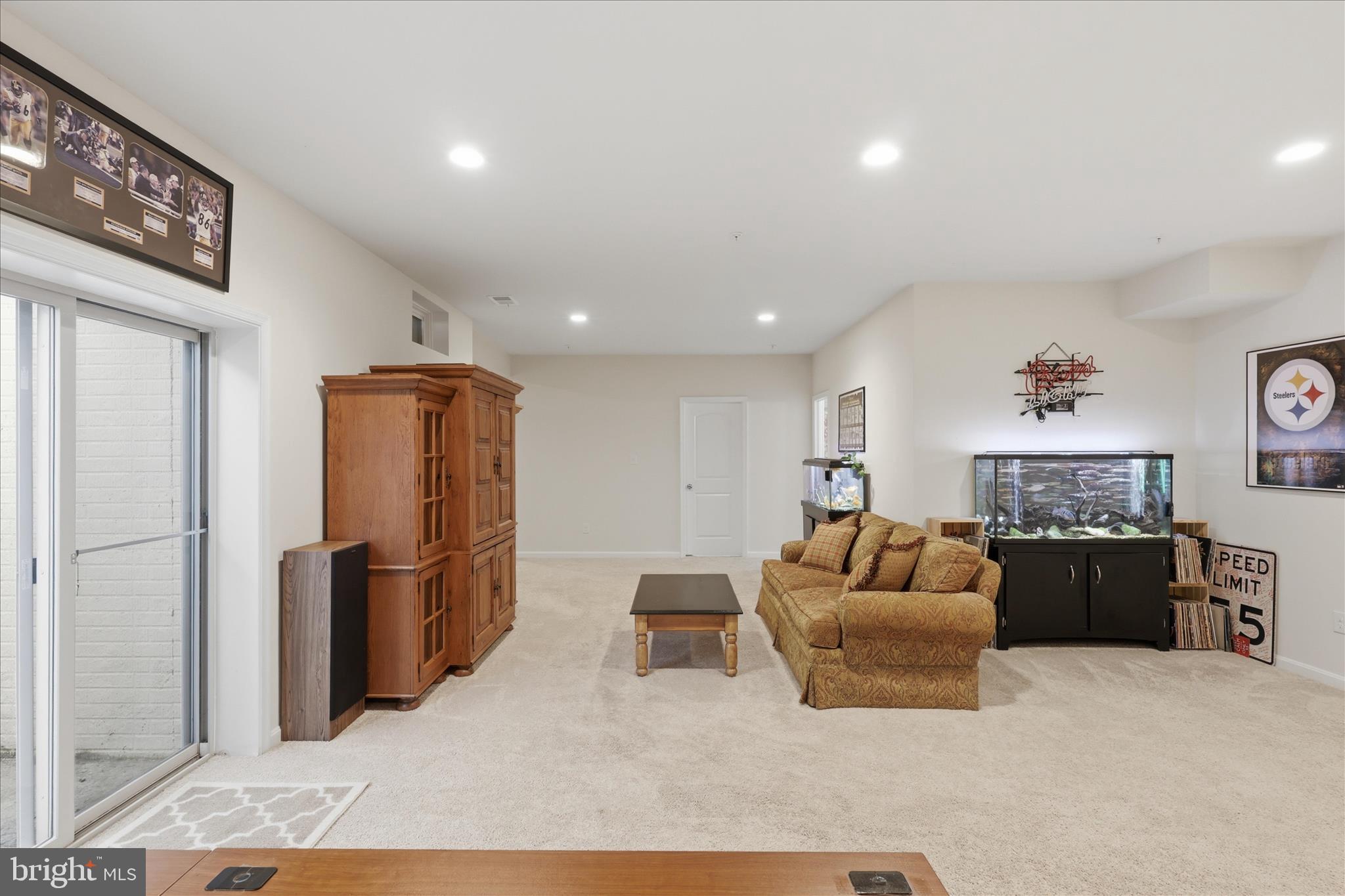 6606 Corbel Way Frederick, MD 21703 - Photo 43 of 60 a living room with furniture and a refrigerator