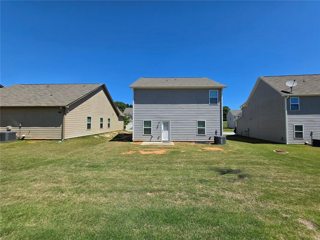 899 Independence Avenue Pendergrass, GA 30567 - Photo 16 of 16 a house with huge green field in front of it