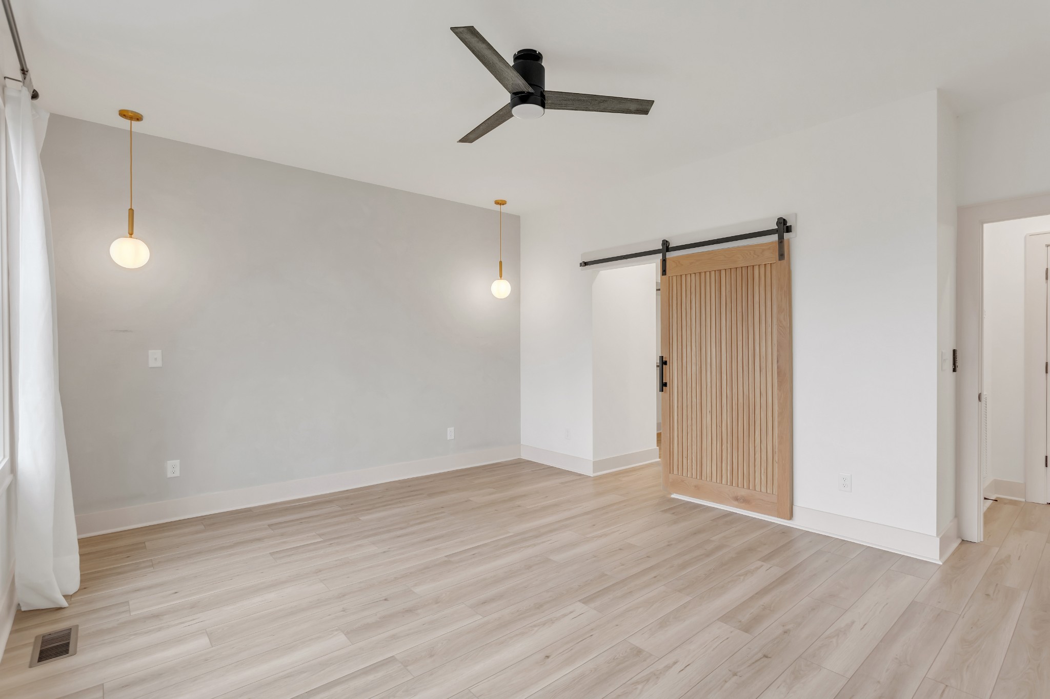 2140 Abiff Road Burns, TN 37029 - Photo 15 of 40 a view of an empty room with wooden floor and a ceiling fan