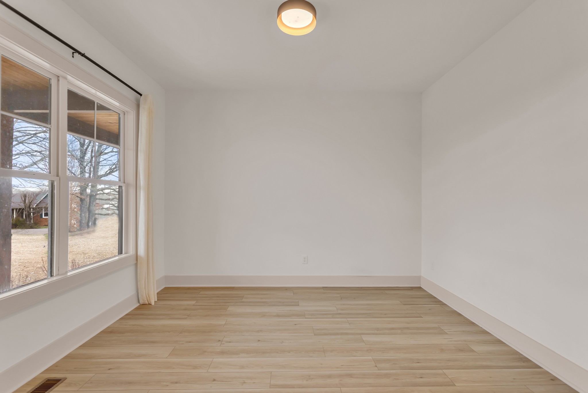 2140 Abiff Road Burns, TN 37029 - Photo 19 of 40 a view of an empty room with wooden floor and a window